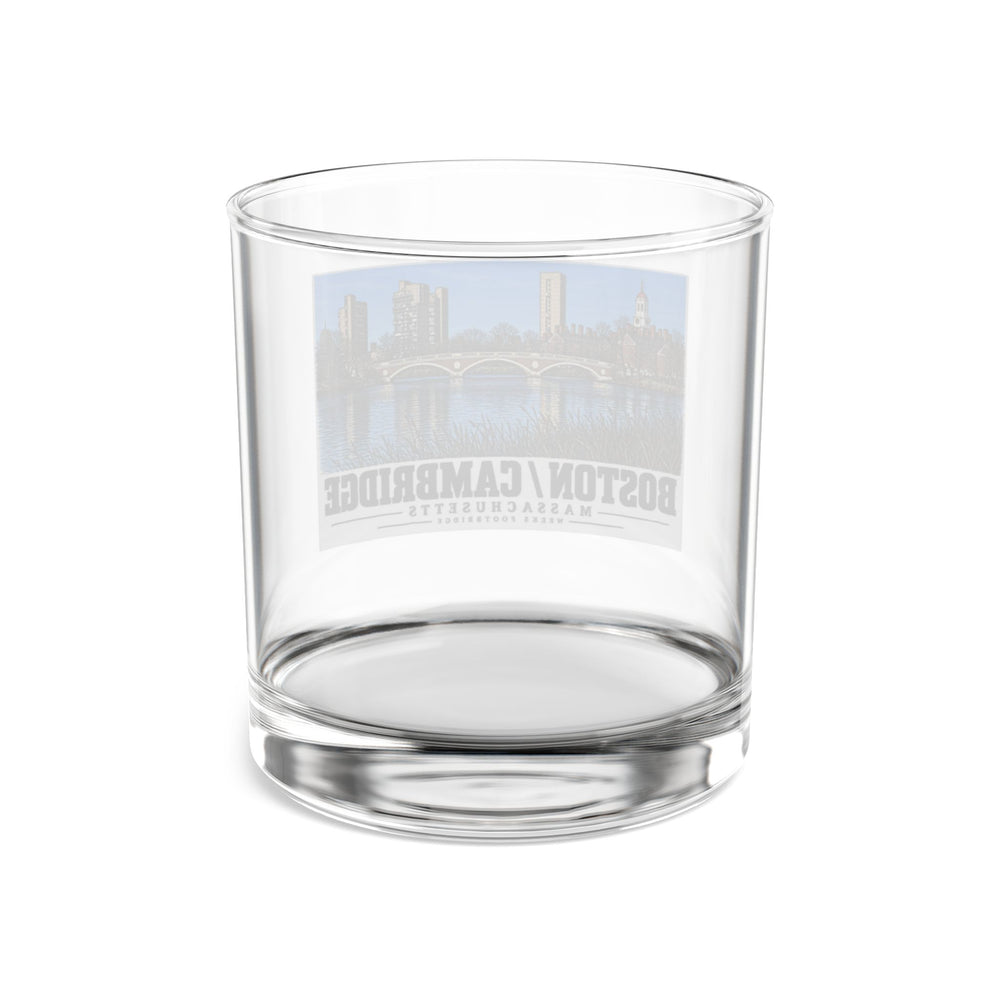 Rear view of clear rocks glass with Weeks Footbridge stone arches and riverside towers print and reversed lettering visible through the glass