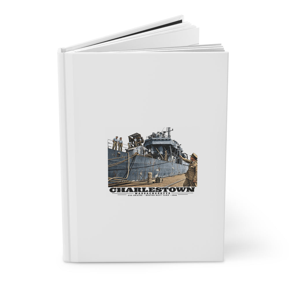 Angled front-cover view of the USS Braine matte hardcover journal, slightly open.