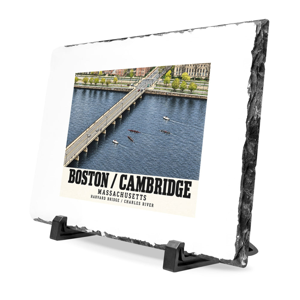 Angled rough-edged slate display on black stands showing Harvard Bridge aerial view with scullers on the Charles River artwork
