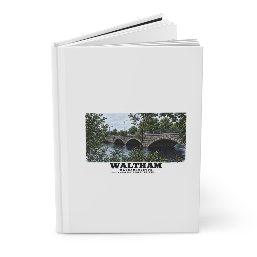 Partly opened white hardcover journal showing Prospect Street Bridge stone arches and river artwork on the front