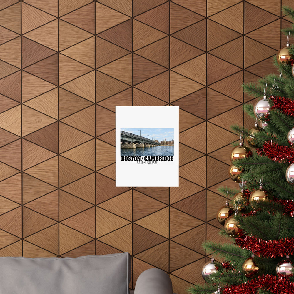 Poster with Harvard Bridge artwork and Boston/Cambridge lettering on a wood wall beside a decorated evergreen