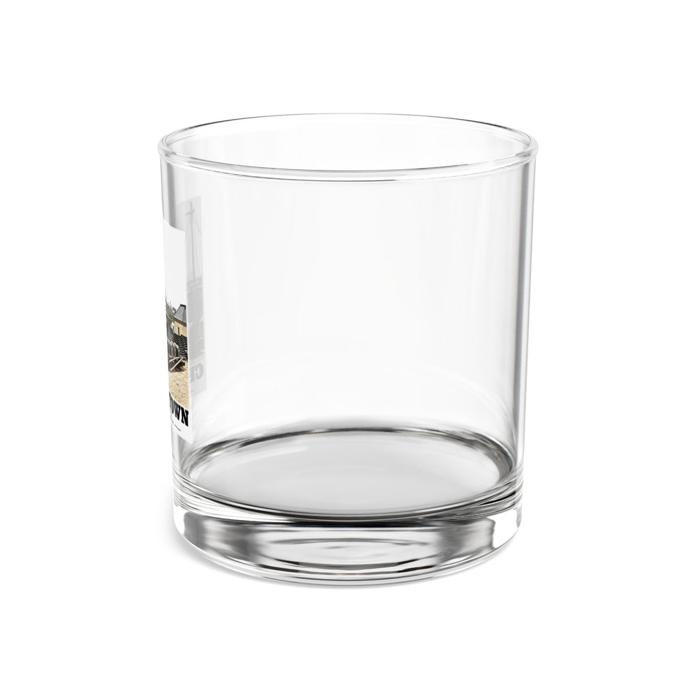 Left side of clear rocks glass showing partial Water Battery artwork