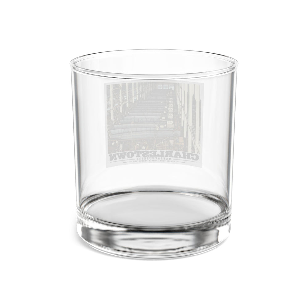 Rear of clear rocks glass showing reversed landing-craft production line artwork through glass