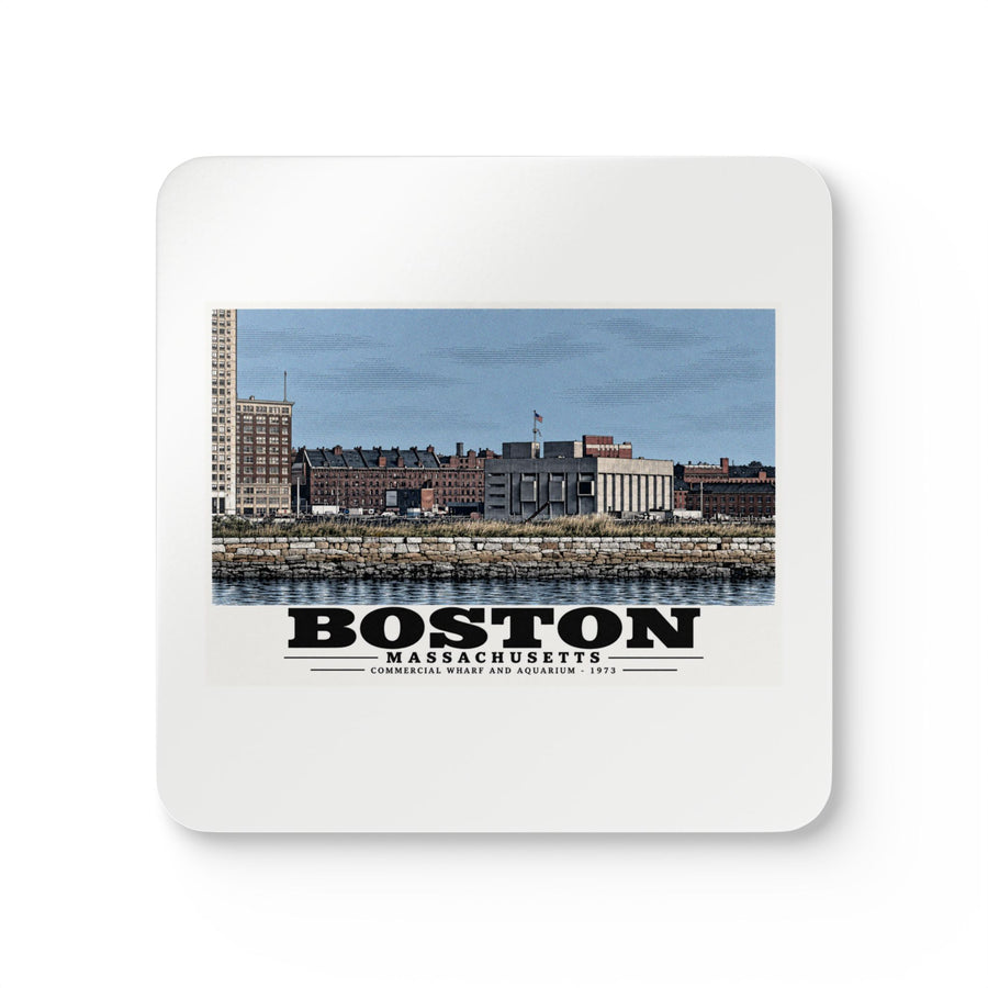 White square coaster showing Commercial Wharf and Aquarium waterfront buildings, stone seawall and harbor water artwork and Boston lettering