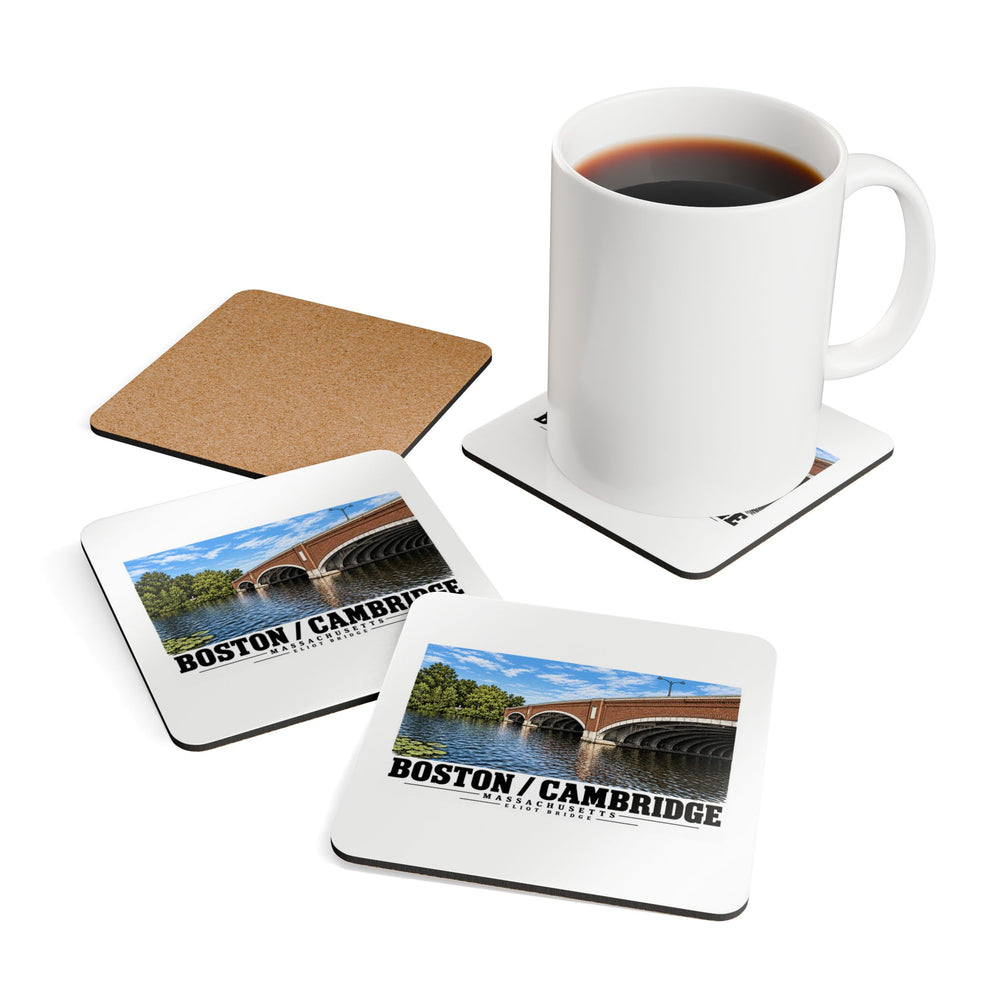 Coasters showing Eliot Bridge close red brick arch view artwork beside a plain white mug of coffee and a coaster's cork reverse