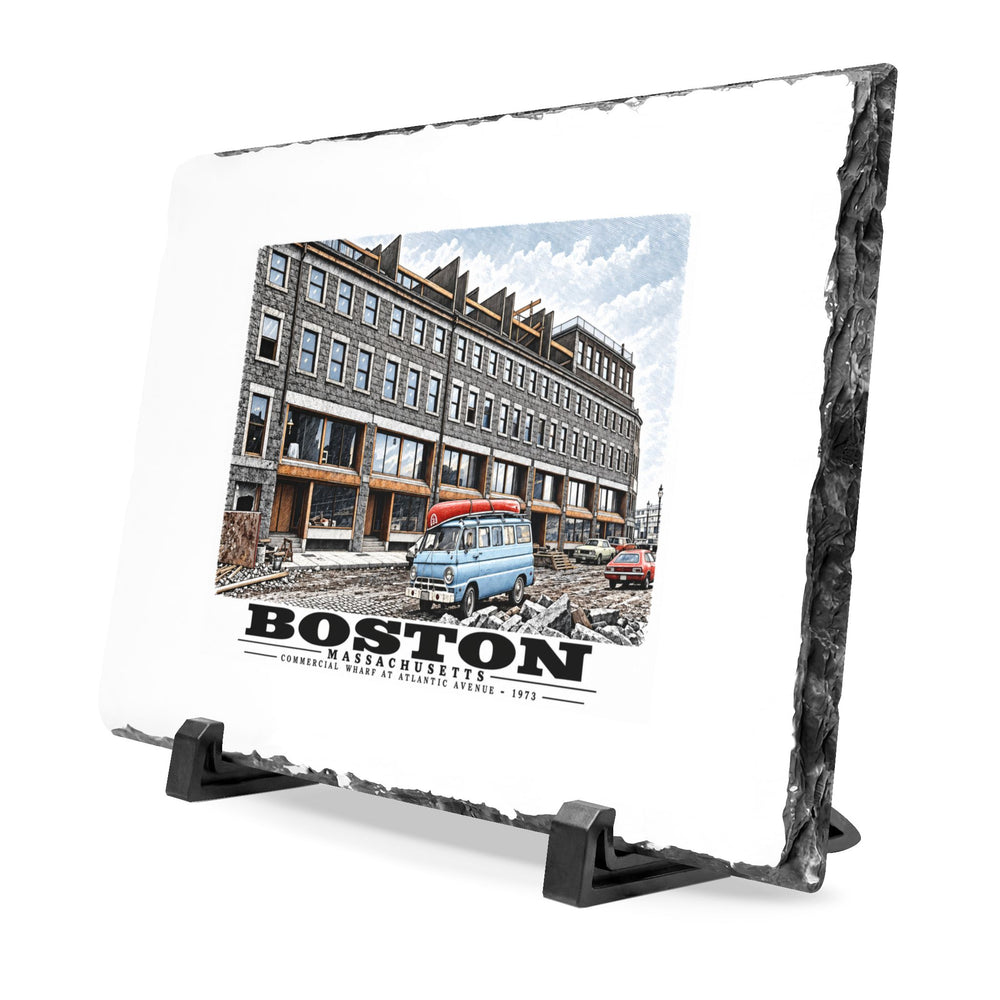 Angled rough-edged slate display on black stands showing Commercial Wharf Street buildings, blue van and renovation debris artwork