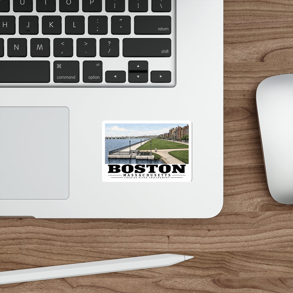 Sticker showing Charles River Embankment riverside path, lawn and buildings artwork on a laptop beside its keyboard