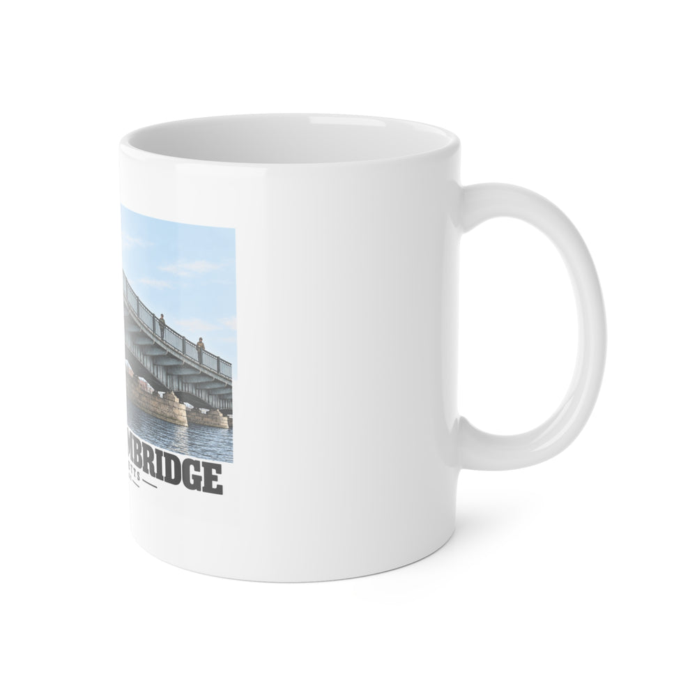 White mug with handle on the right and part of the Harvard Bridge print visible on the left