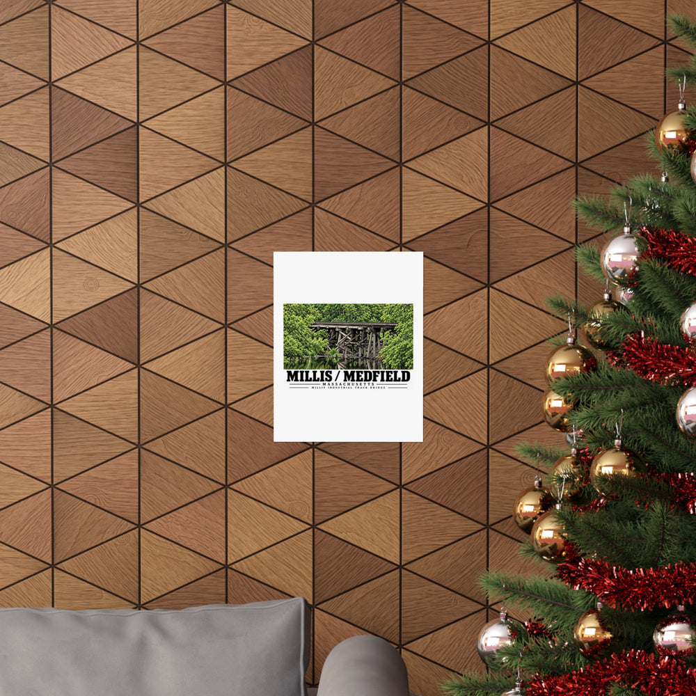 Millis Industrial Track wooden railway trestle and green foliage poster on a wood wall beside a decorated evergreen
