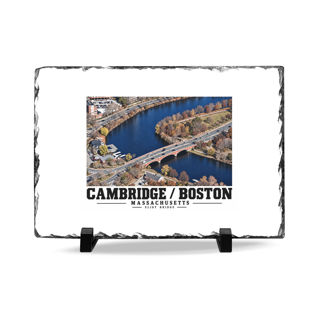 Rough-edged slate display on two black stands with Eliot Bridge aerial river view artwork and Cambridge/Boston lettering