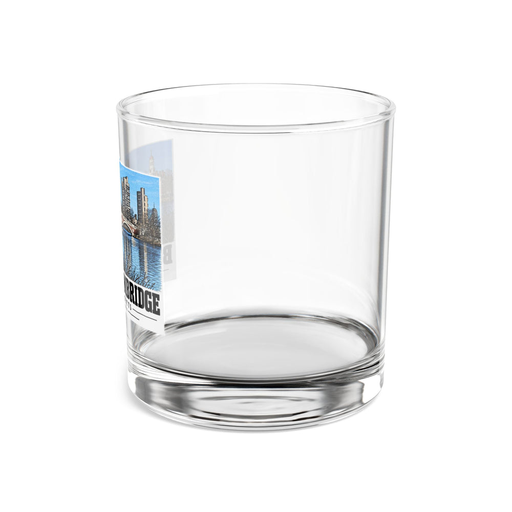 Side view of clear rocks glass with mostly unprinted surface and part of Weeks Footbridge stone arches and riverside towers print at left