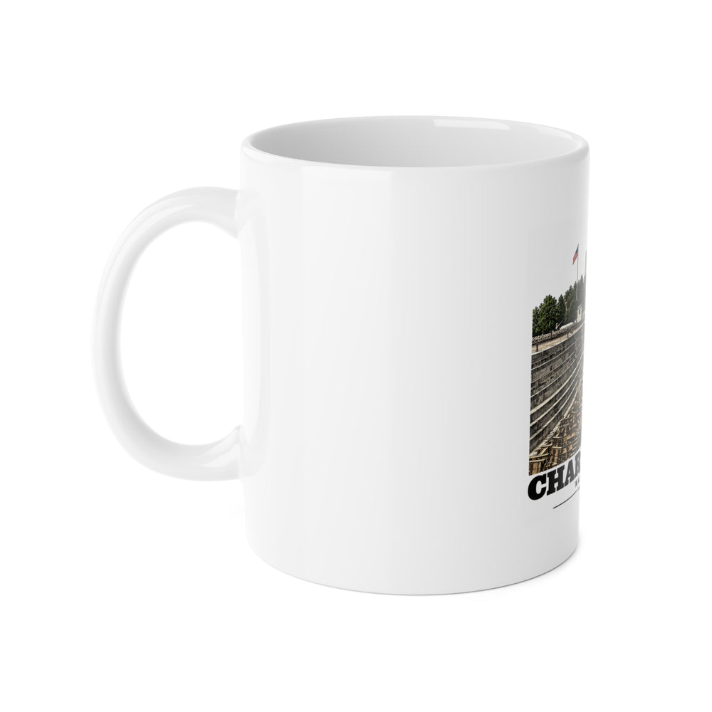 Left side of white ceramic mug showing handle and partial dry-dock artwork