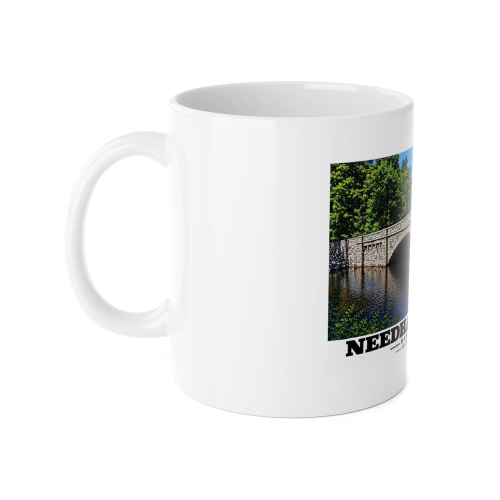 White mug with handle at left and part of the South Street Bridge stone arch and river print at right