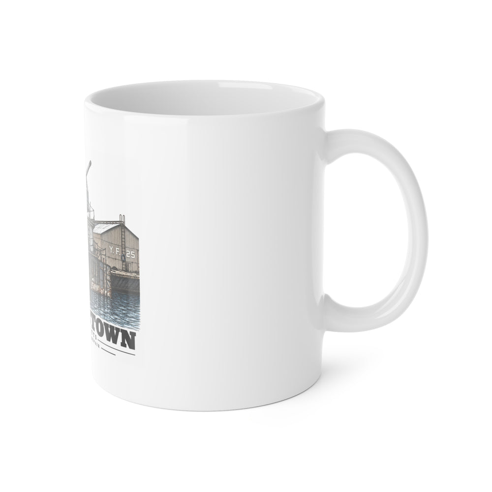 Right side of ceramic mug showing handle and edge of USS Nelson artwork
