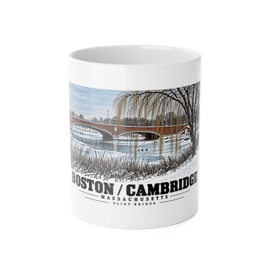 White mug showing Eliot Bridge winter river view with snow and bare trees artwork and Boston/Cambridge lettering