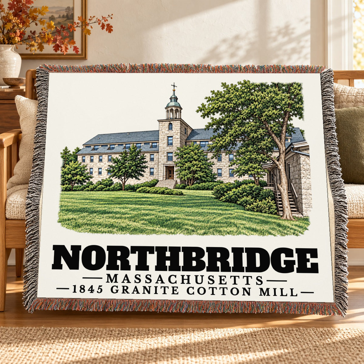1845 Granite Cotton Mill woven blanket draped on a sofa in a living room — Northbridge, Massachusetts