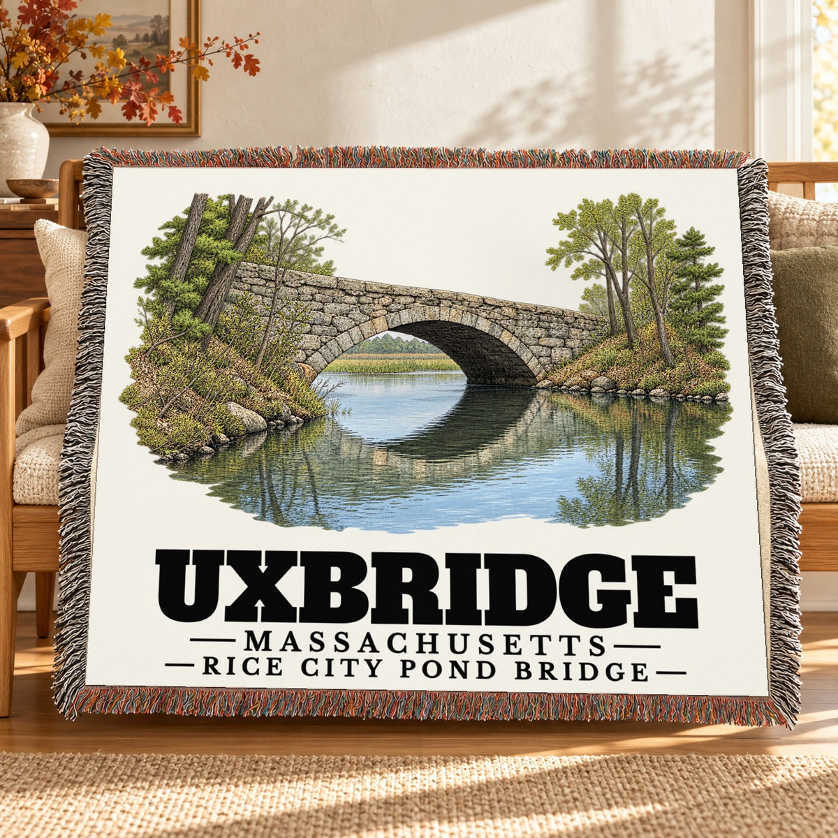 Rice City Pond Bridge woven blanket draped on a sofa in a living room — Uxbridge, Massachusetts