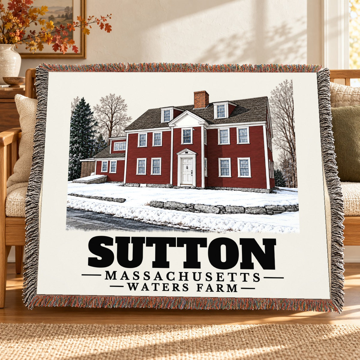 Waters Farm woven blanket draped on a sofa in a living room — Sutton, Massachusetts