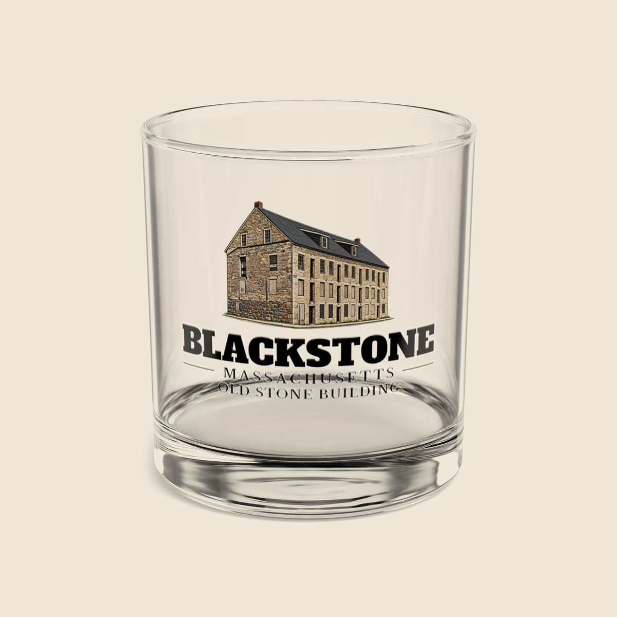 Blackstone Old Stone Building rocks glass with colored engraving, shown on a cream background