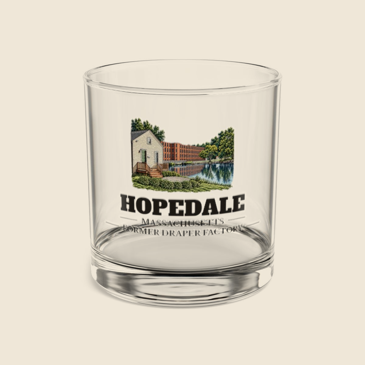Hopedale Former Draper Factory colored engraving on a 10 oz clear rocks glass, cream display background