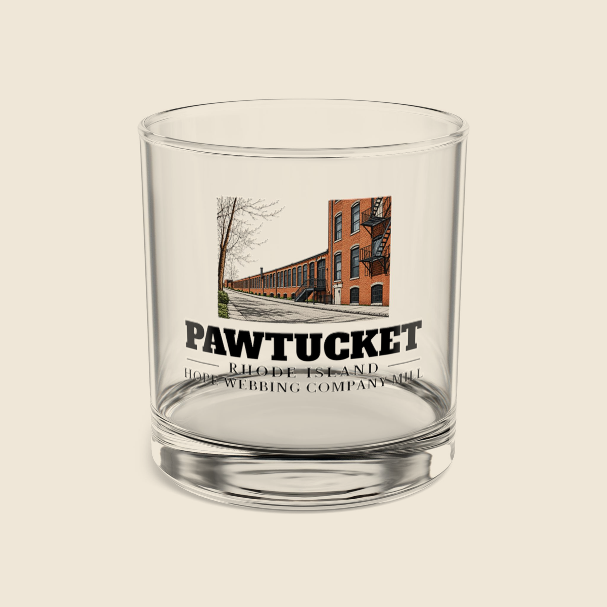 Pawtucket Hope Webbing Company Mill rocks glass with colored engraving, shown on a cream background