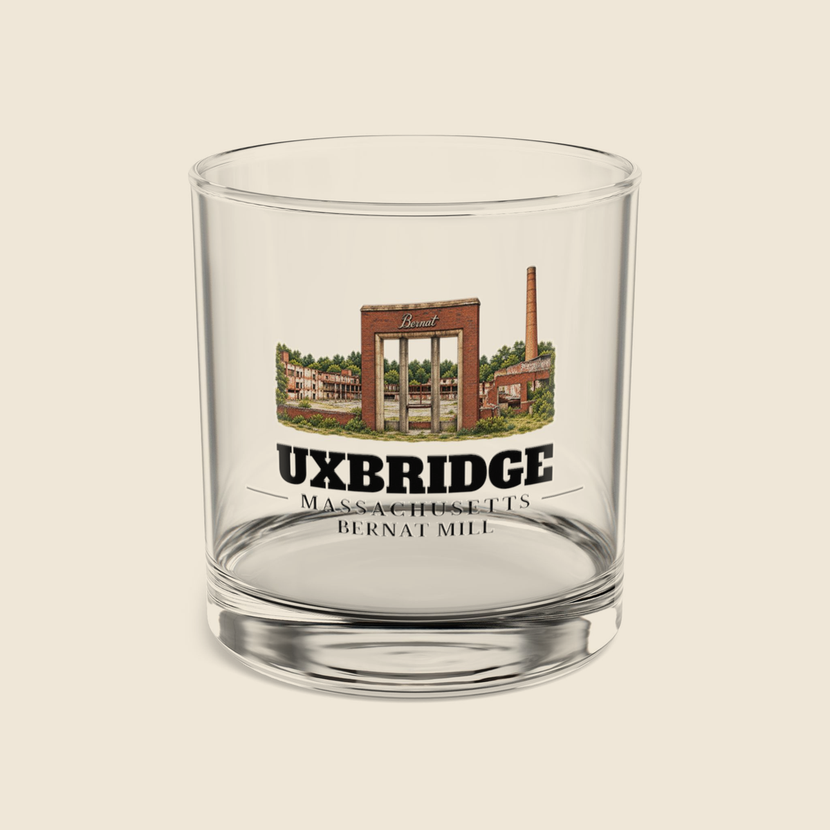 Uxbridge Bernat Mill rocks glass with colored engraving, shown on a cream background