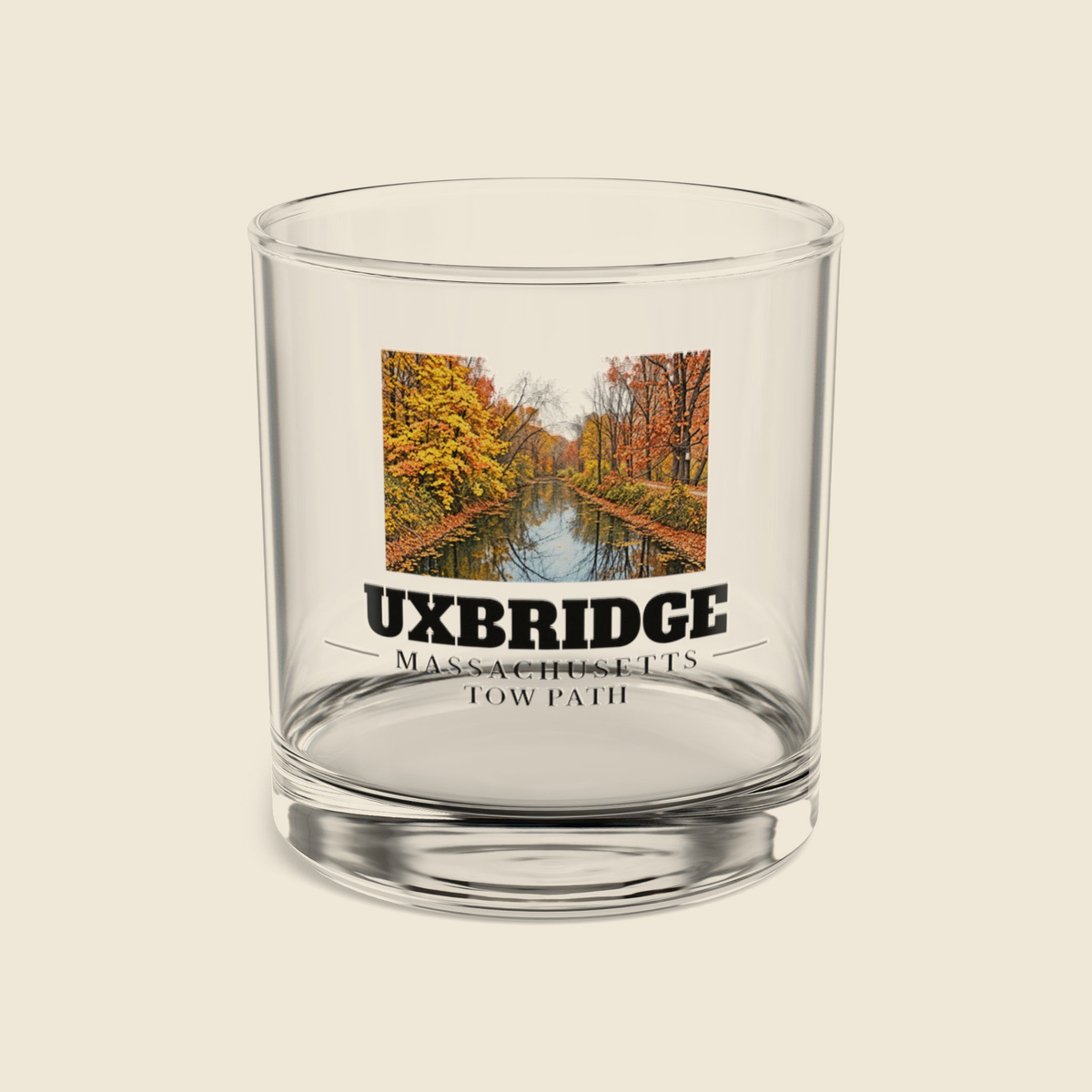 Uxbridge Tow Path rocks glass with colored engraving, shown on a cream background