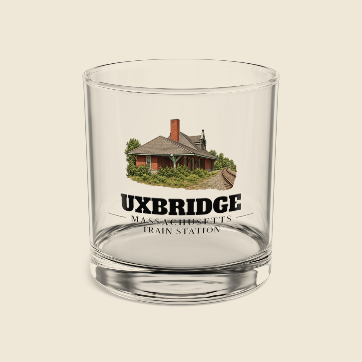 Uxbridge Train Station rocks glass with colored engraving, shown on a cream background