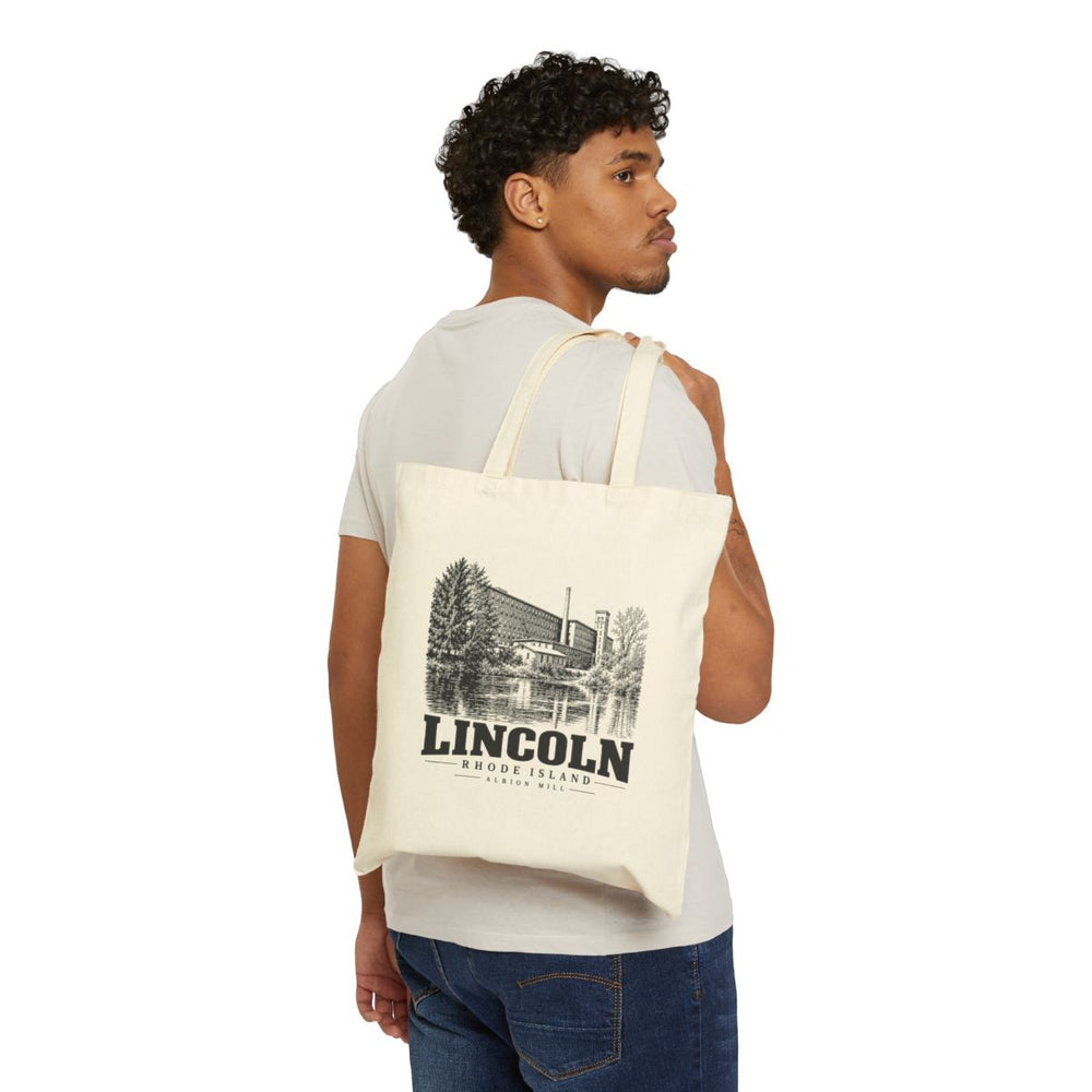 A person carrying a Natural Liberty Bags OAD113 tote with Albion Mill artwork on the front, Lincoln, Rhode Island